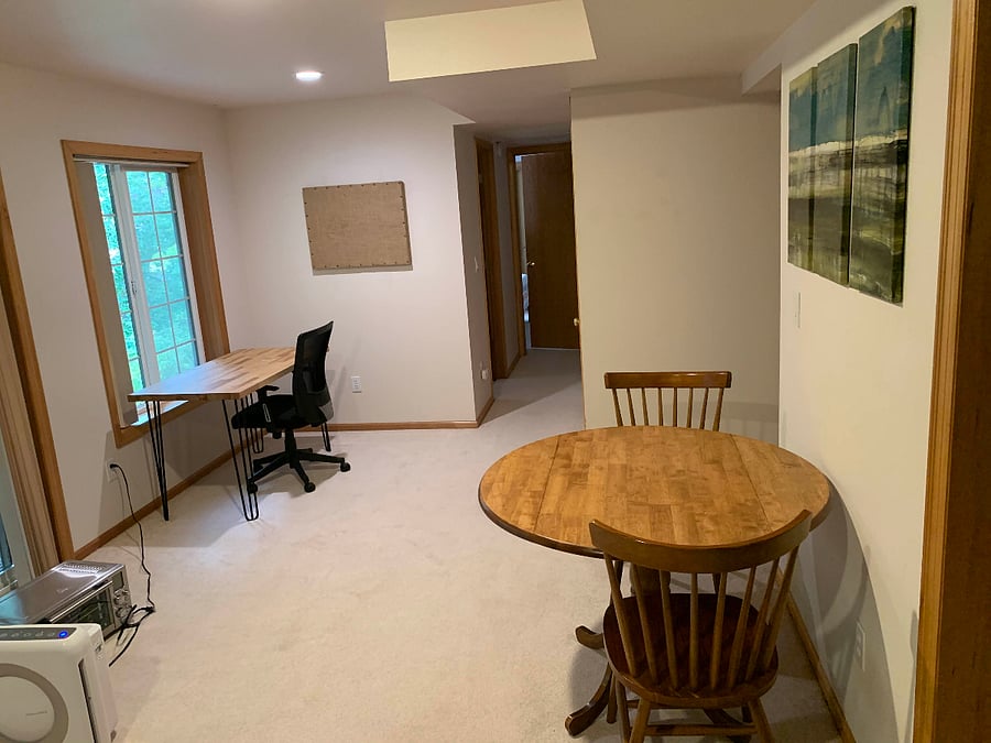 A dining table and desk facing the shade garden make up the main living area.