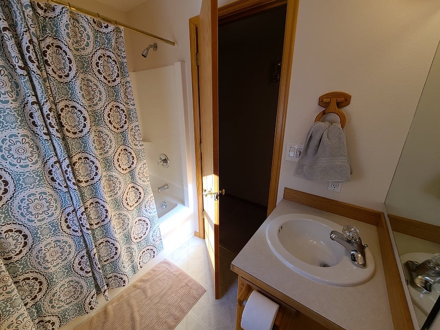 The bathroom features a full tub.