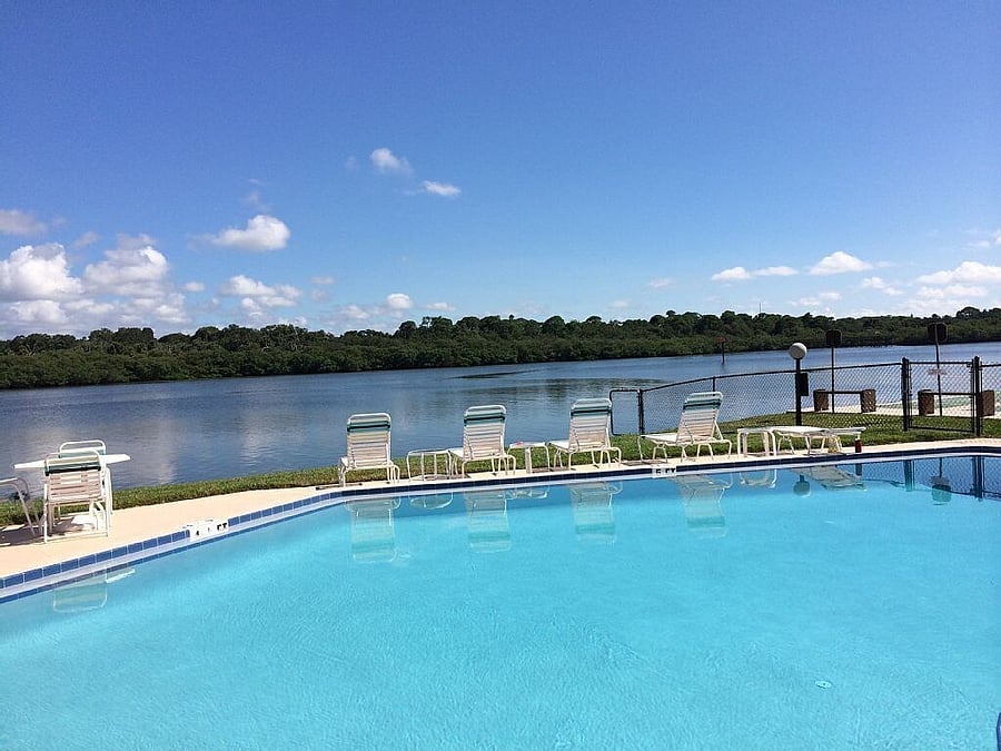 Stepping out your back sliding door and a 2 minute walk to the heated pool! While soaking up the sun, youll see Dolphins splashing and the local Nature Reserve till sunset!!
