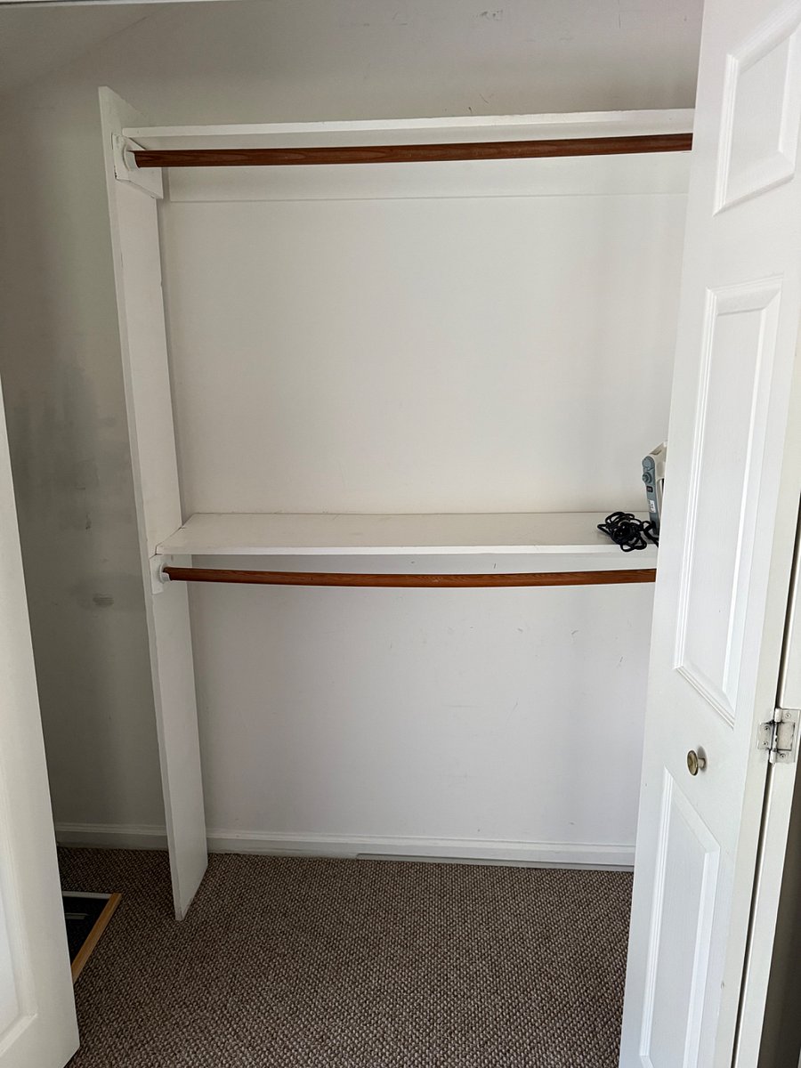 Large bedroom closet with lots of storage room and a iron