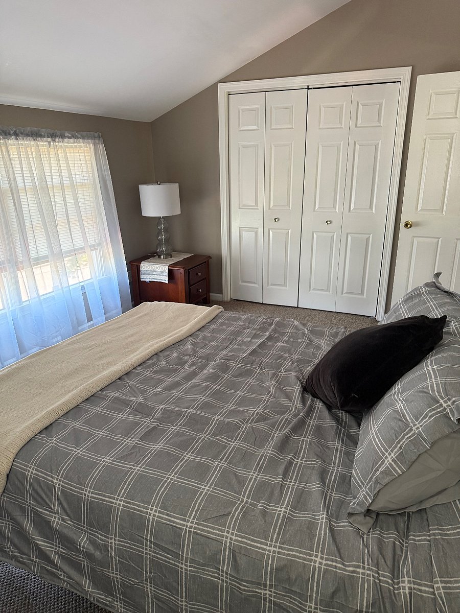 Queen bed with linens pillows and ready for sleeping