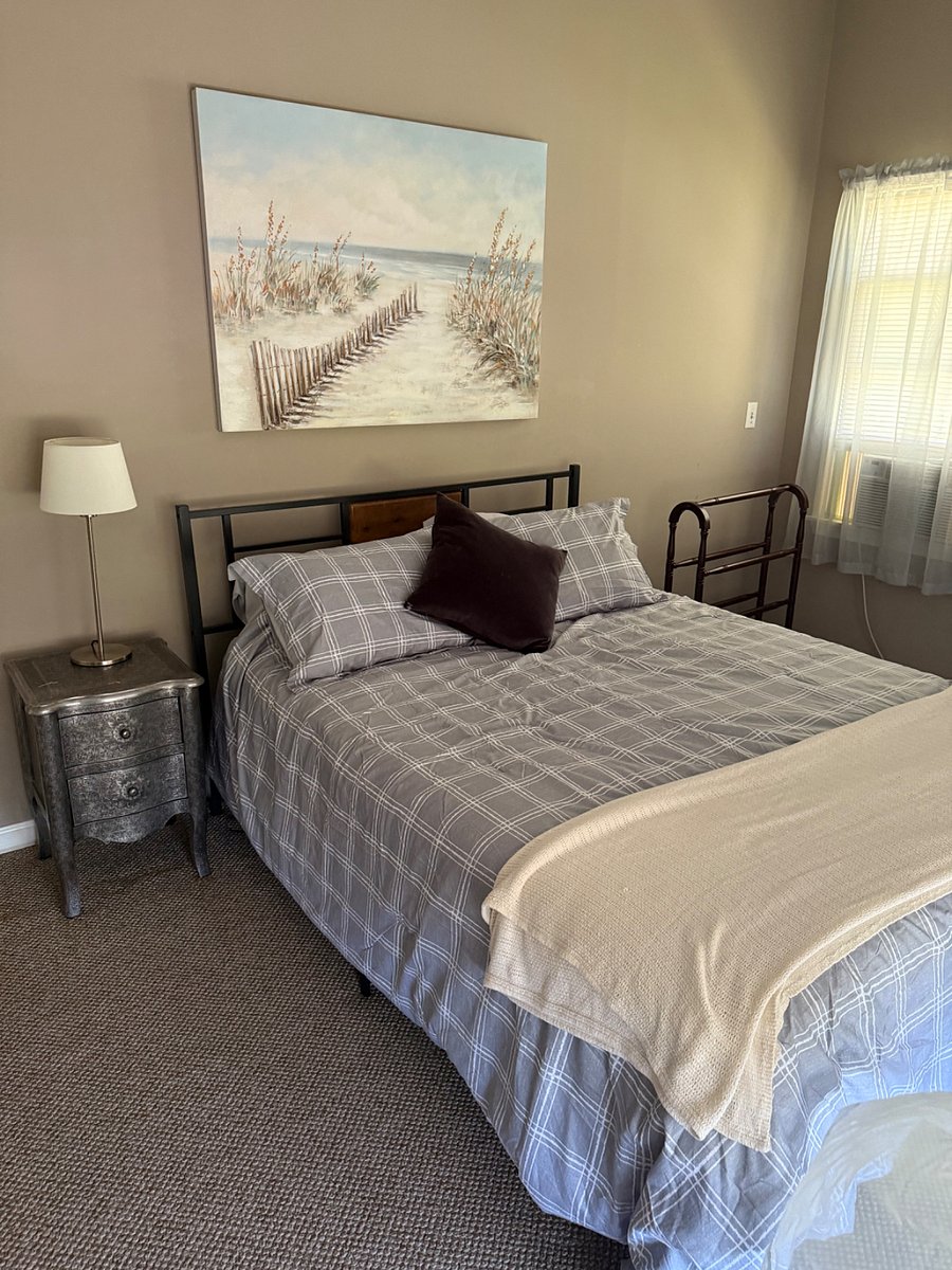 Queen size bed with nightstand, dresser, lamps and double window in front and large side window for great ventilation. AC IN bedroom window
