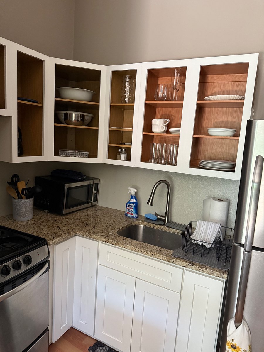 Kitchen cabinets door to be put back up freshly painted. The cabinet shows everything you need to cook with and eat with.