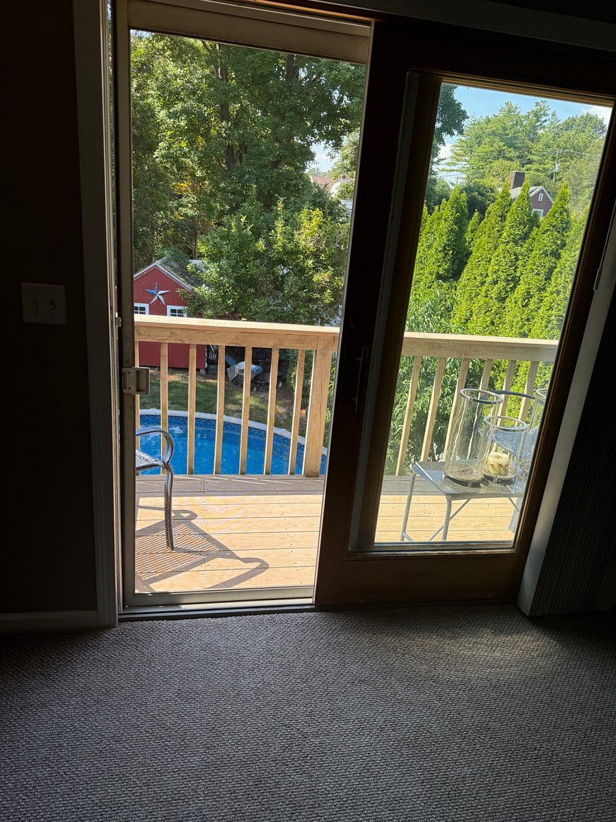 Beautiful sliding doors to serene porch with chairs