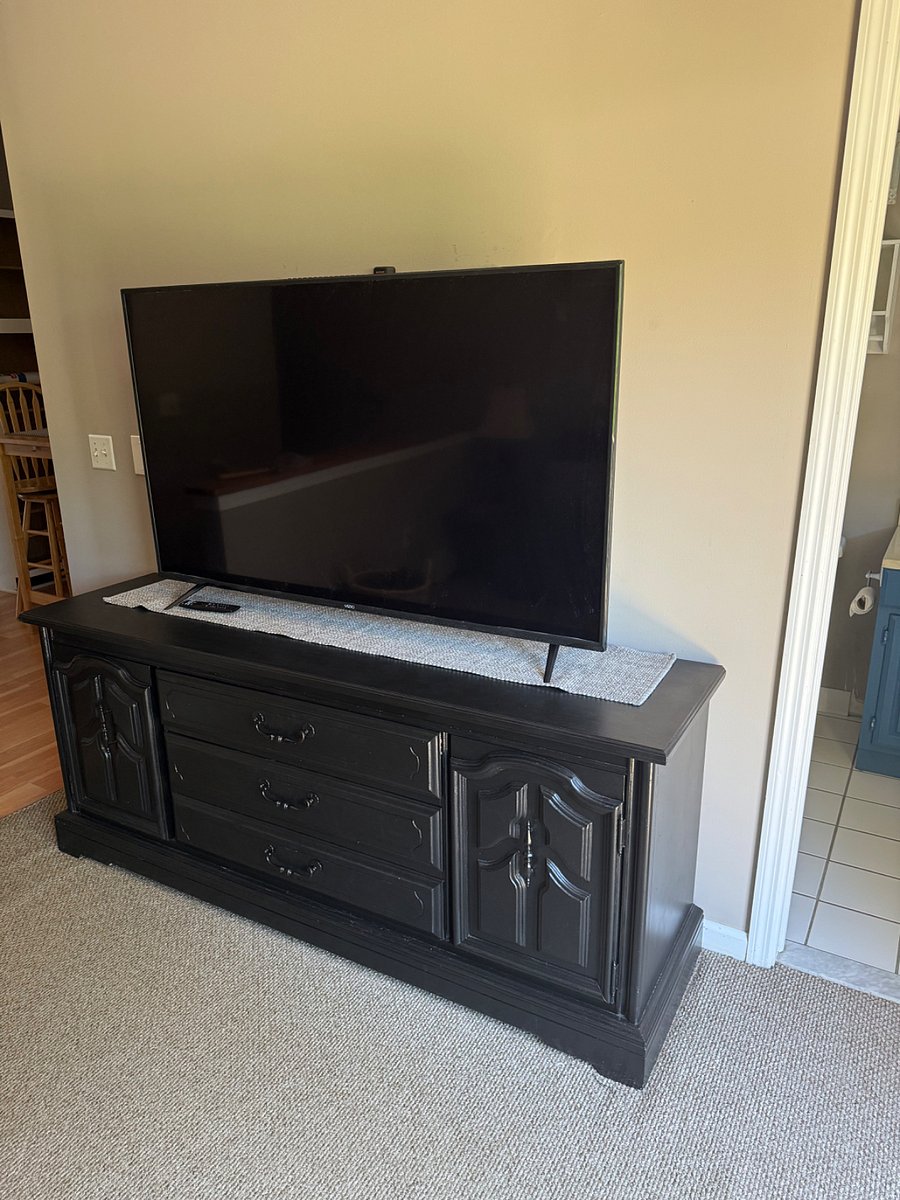 Huge tv for relaxing and large cabinet with plenty of storage