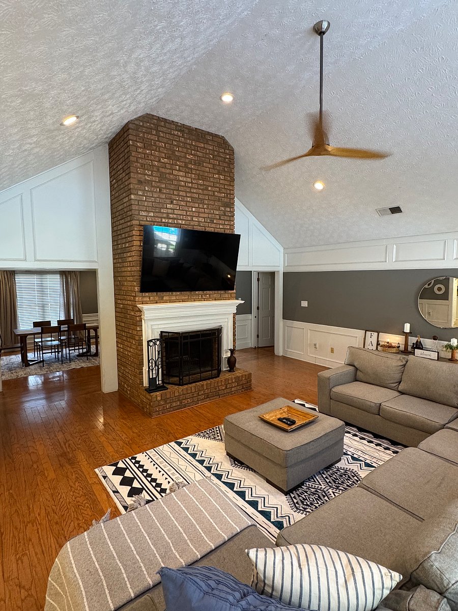 View of living room from opposite end. Large 75 Smart TV, view of dining room area. Kitchen / breakfast area is to the left of this photo. Bedrooms through hallway on right of this photo. 