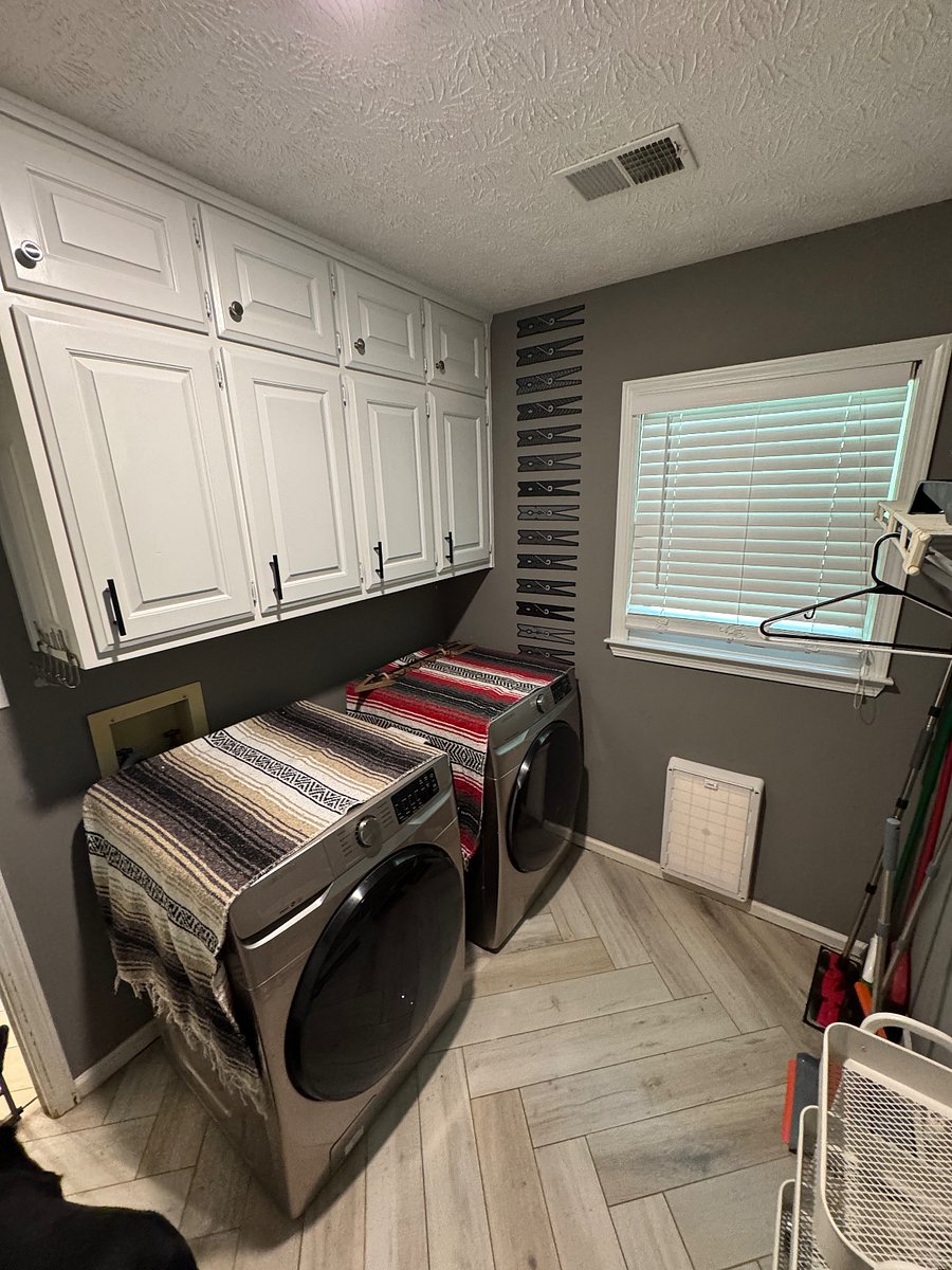 Laundry room equipped with brand new, full sized washer and dryer