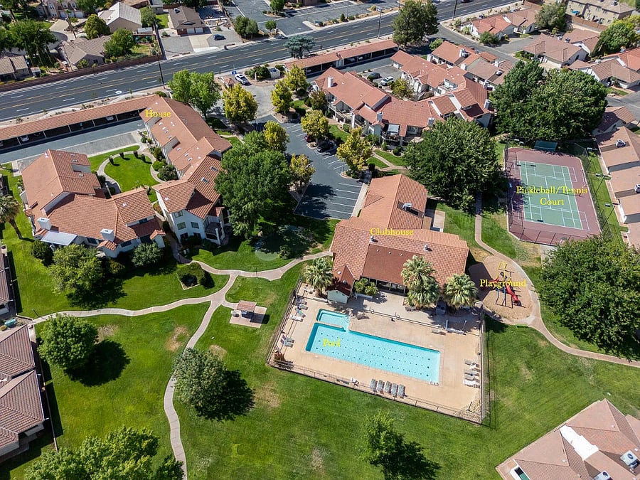 Aerial view showing the condo & amenities. Located in a beautiful part of St George, there are views of the red-rock canyons surrounding the property. Snow Canyon State Park is only 15 minutes down the road!
