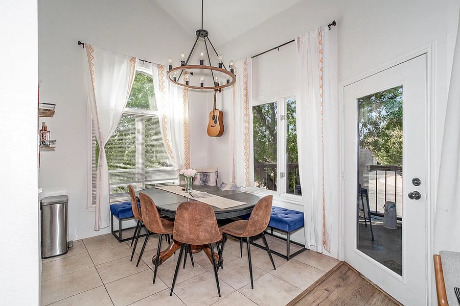 Dining table with comfortable seating for 8, spacious enough for meals, game nights, or working from home. The door on the right leads to the furnished balcony!