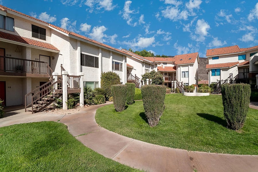 The condo is located on the top floor of the complex. In this photo, the door can be seen at the top left, unit 212. It is located on the corner and only has neighbors on one side of the unit.