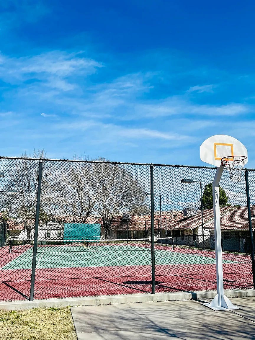 Full basketball court for pickup games with the tennis and pickle ball courts located behind.