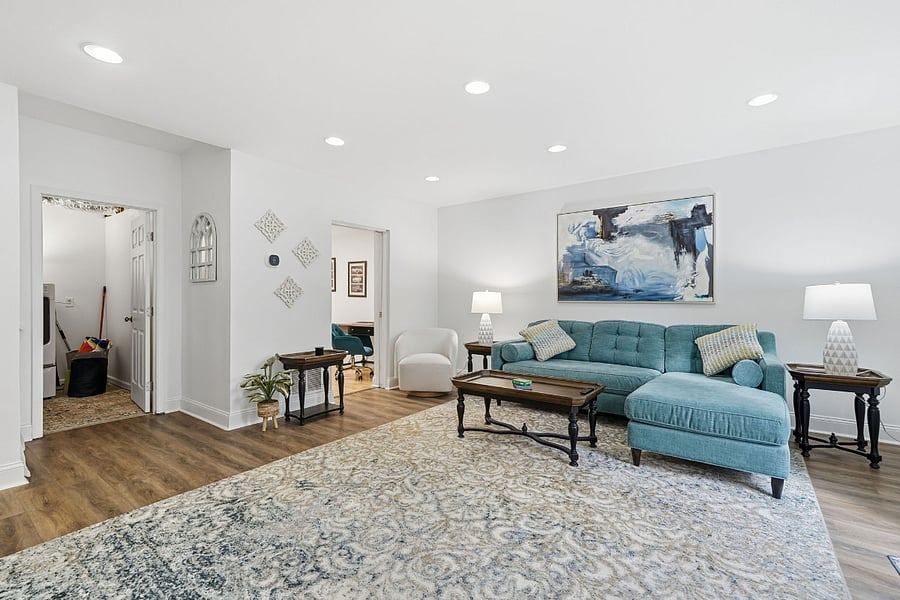 Super cozy sofa with leg rest and blankets for snuggle time relaxation. Along with two brand new swivel chairs, side tables, coffee table and lamps. Featuring a 60" smart TV and Fireplace console with storage.