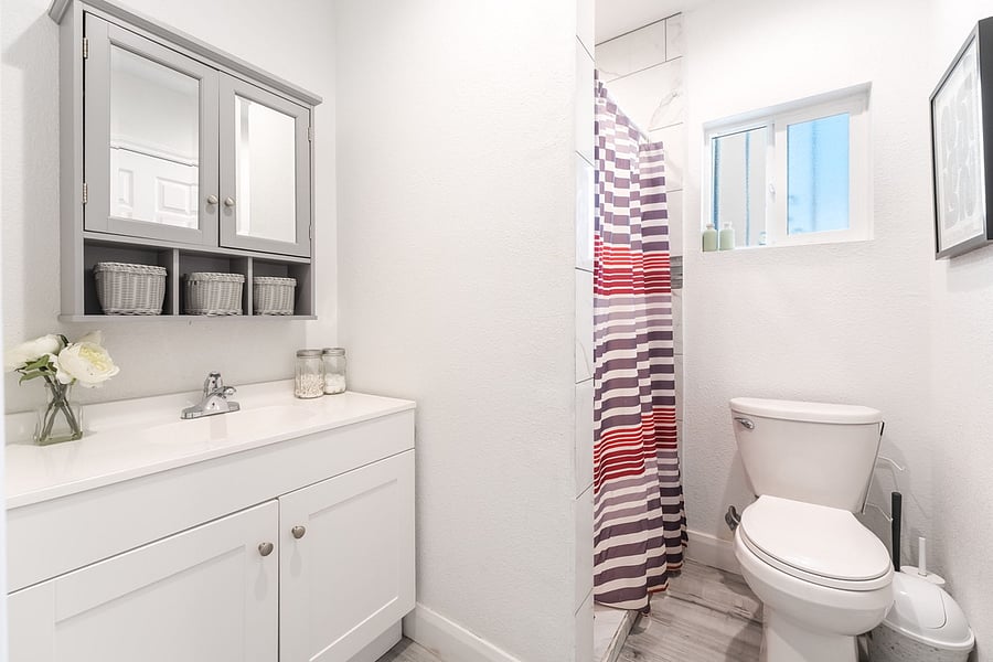 Full bath connected to primary bedroom stocked with toiletries