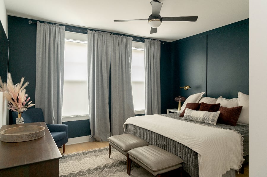 Main bedroom with remote controlled fan, expansive light, room darkening curtains, reading sconces, and Smart TV
