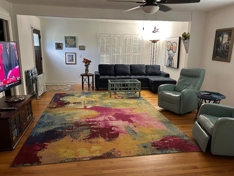 Large living room from entered from your front porch. New deep blue velour sectional. 2 automatic light blue recliners. Large Smart TV