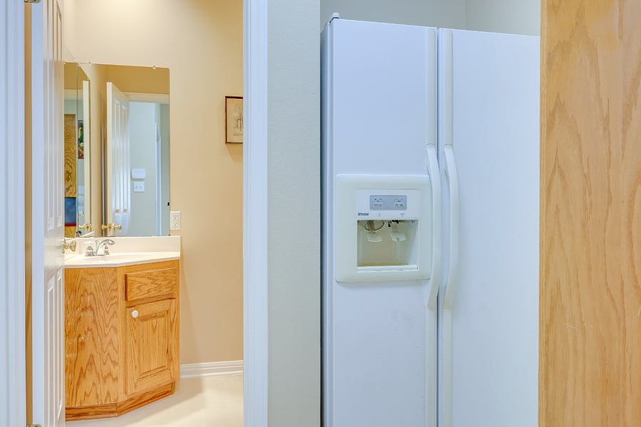 Half bath off kitchen with additional side-by-side refrigerator