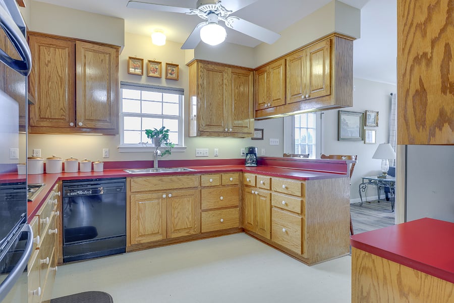 Kitchen with plenty of counter space, window overlooking the backyard, and under cabinet lighting