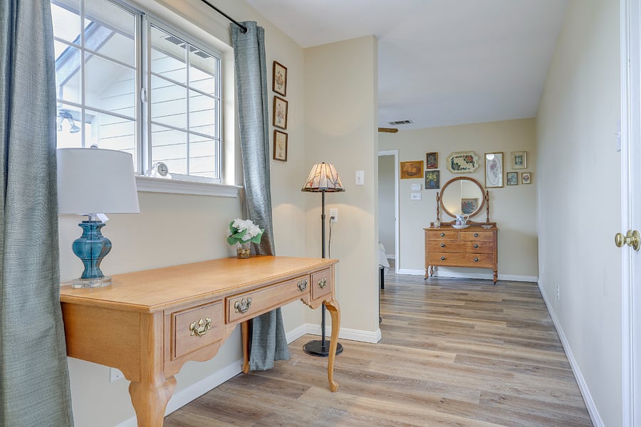 Primary room with desk area and access to walk-in closet directly across for desk