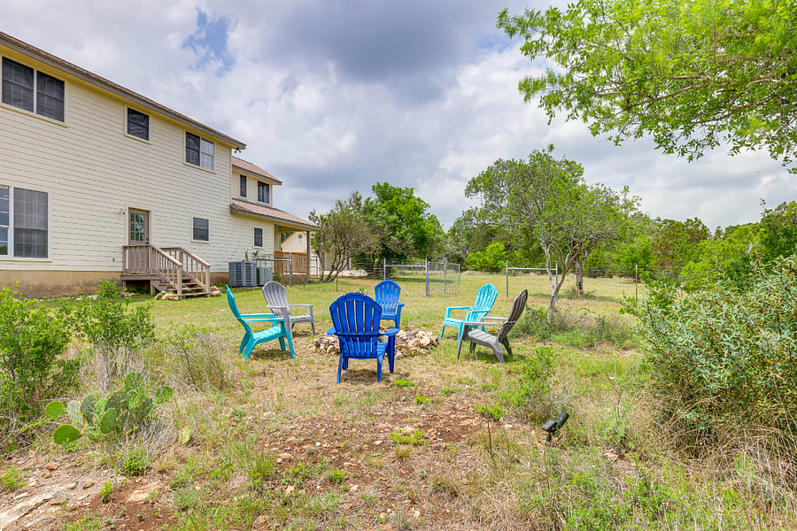 Backyard with view of back porch and dog yard in the background