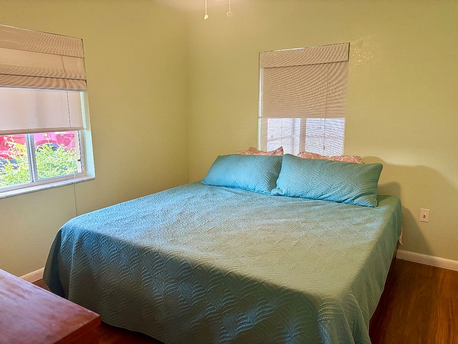 Peaceful primary bedroom with large closets and 2 types of pull down shades for cozy comfort after a long shift.