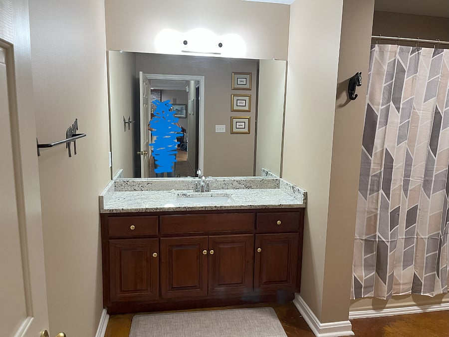 Bathroom with single sink and granite countertop.