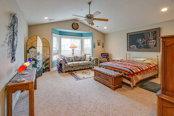 Bay window lets evening sunlight fill primary suite.