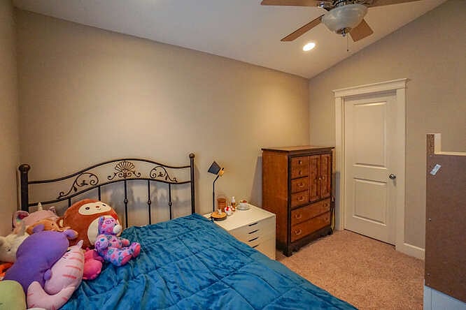 This bedroom has a walk-in closet & ceiling fan.