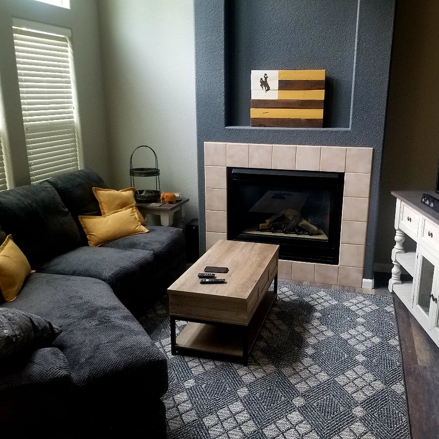 The living room is on the main floor and has great lighting with a two story windows. It is an open concept with the kitchen