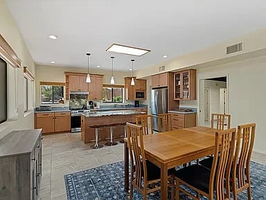 Dining room with kitchen in background