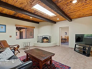 Den with wood burning fireplace