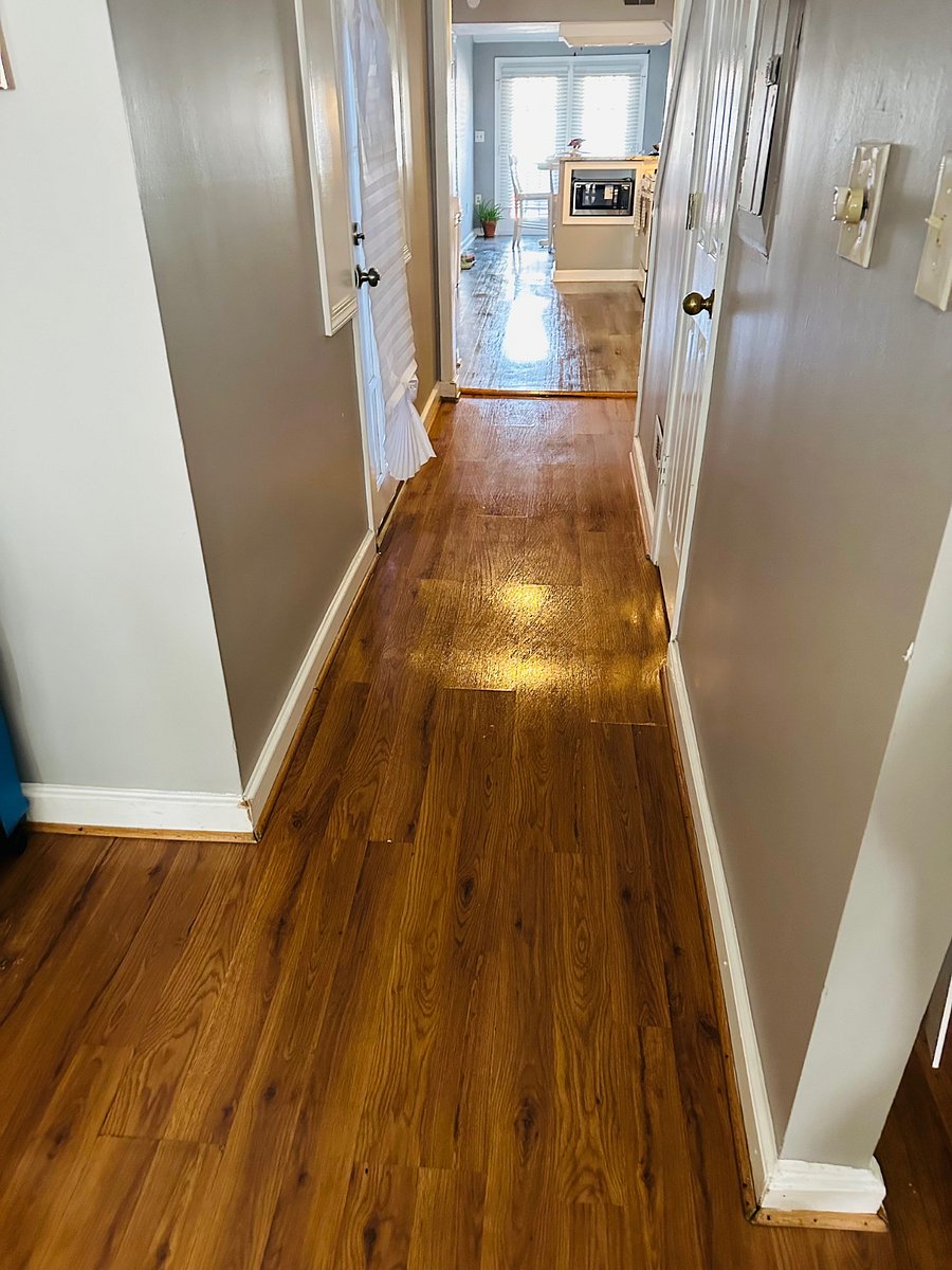 hallway leading to half bathroom and to the kitchen