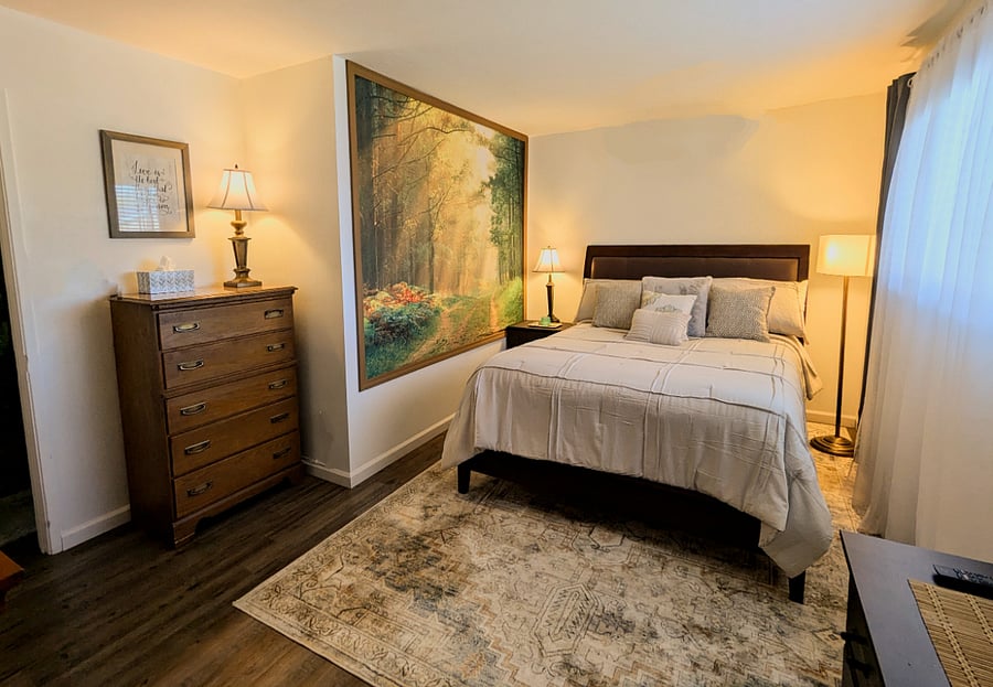 Large bedroom has lots of cozy extra bedding, big closet, and 2 big dressers.