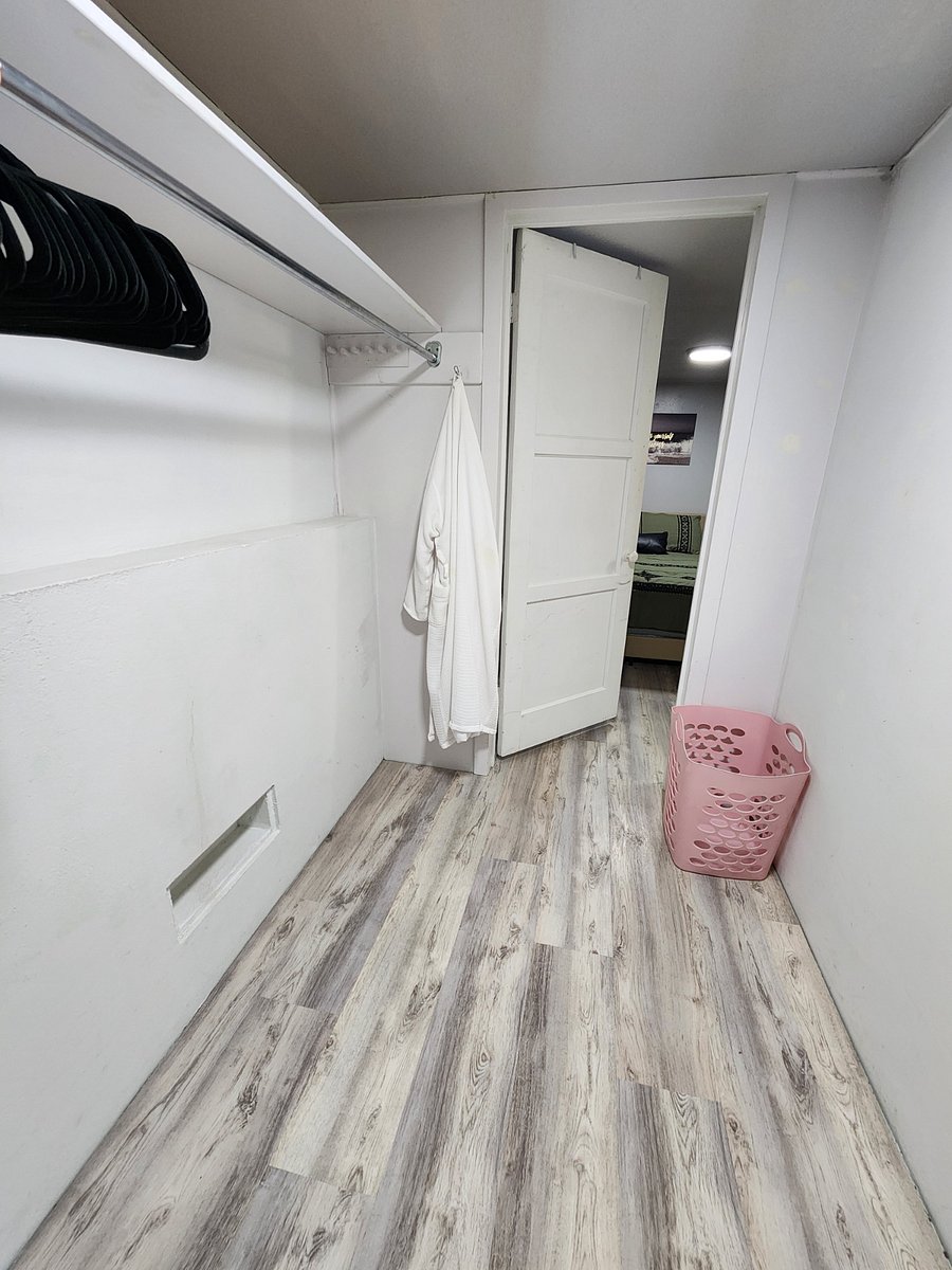 Massive closet with hangers, robe, laundry basket