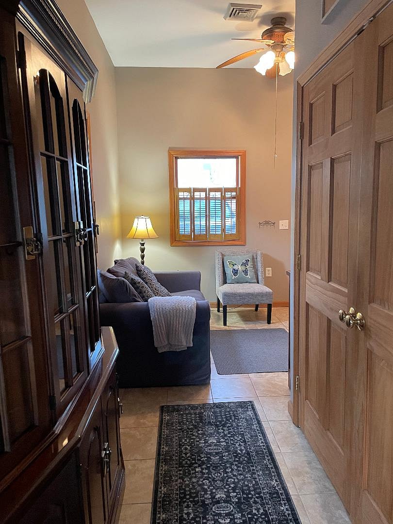 washer dryer closet on right with view of reading nook off of kitchen