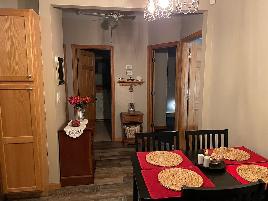 kitchen eating area facing entry to bathroom and 2 bedrooms and work area which goes out to deck in back yard
