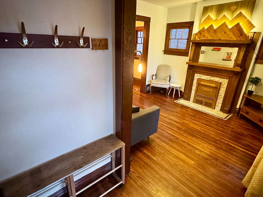 Coat and shoe rack at entry way into Living Room