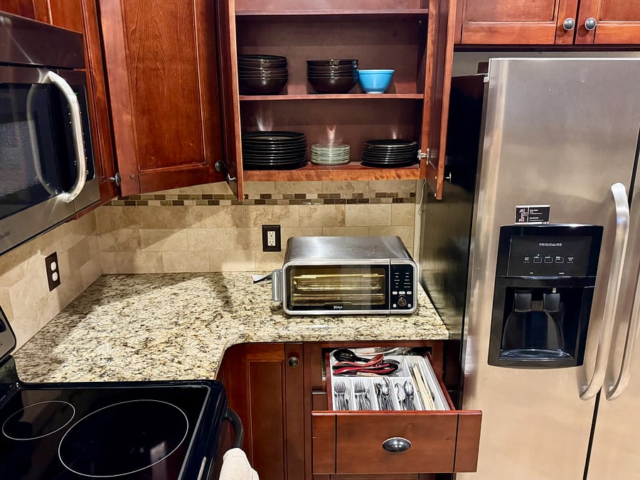 Basic plates/bowls, cups/mugs/glasses, silverware, airfryer/toaster, mircowave, electric stove.