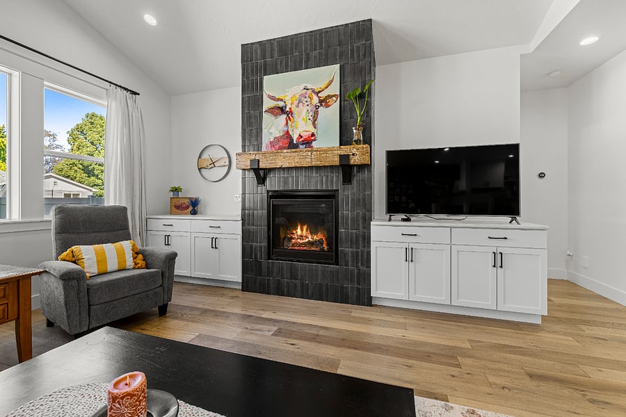 Enjoy the cozy living room with Smart TV and grand fireplace.