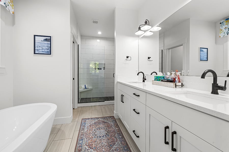 En suite bathroom with soaker tub, large walk-in shower and double sink vanity.