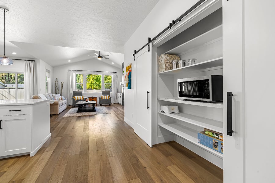 Double barn door pantry with microwave.