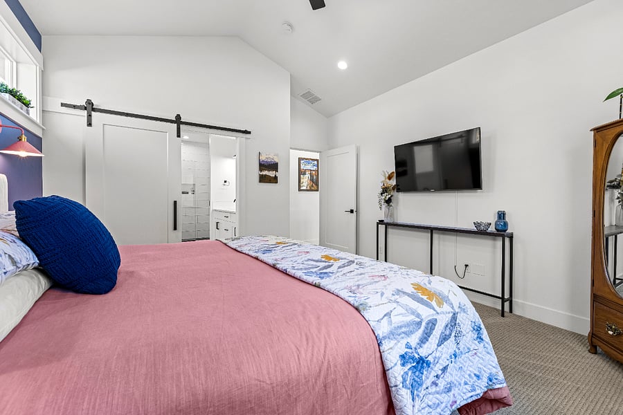 Primary Suite with Smart TV. Barndoor conceals gorgeous en suite bathroom.