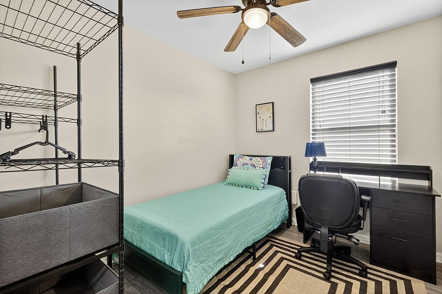 Bedroom 4 featuring a twin-size bed, desk and portable closet