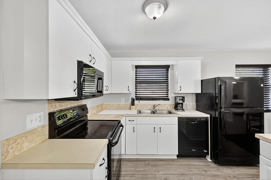 Kitchen is fully equipped with an oven range, microwave, dishwasher, refrigerator / freezer