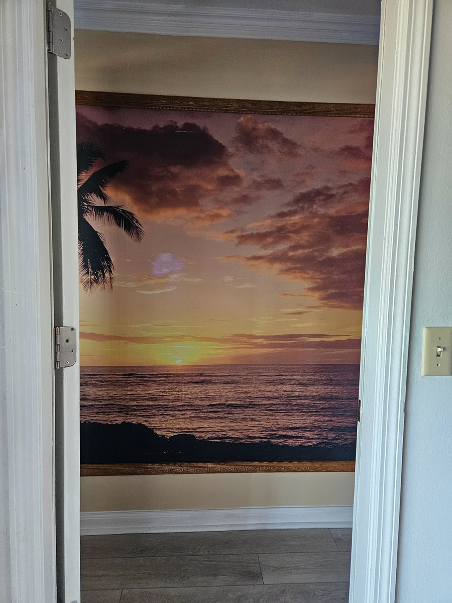 Front Entrance is a floor to ceiling mural of a gold sunrise/sunset