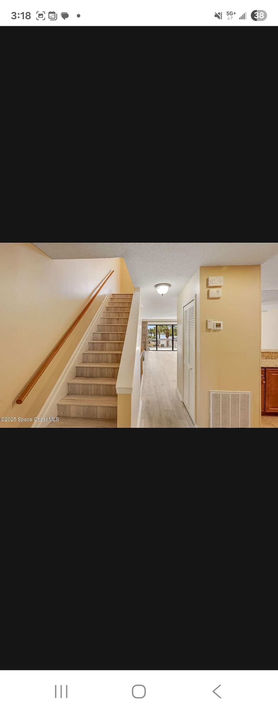Hallway coming from the living room to walk past or enter the kitchen and beyond the camera is the door to the bathroom and bedroom on this floor. Stairway upstairs is to the Master bedroom and the other Bedroom. Both with their own bathrooms.