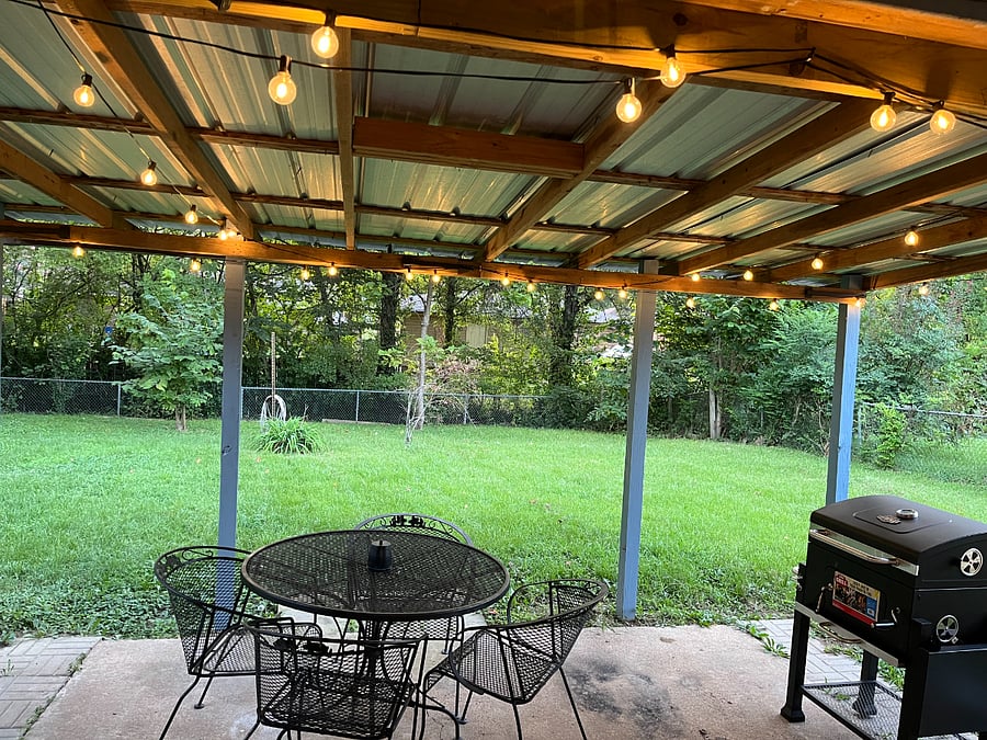 large backyard with patio and bbq grill