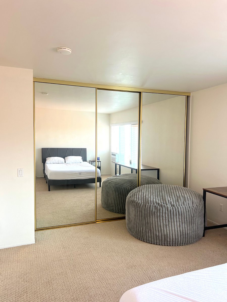 The room has floor-to-ceiling mirrors and plenty of closet space