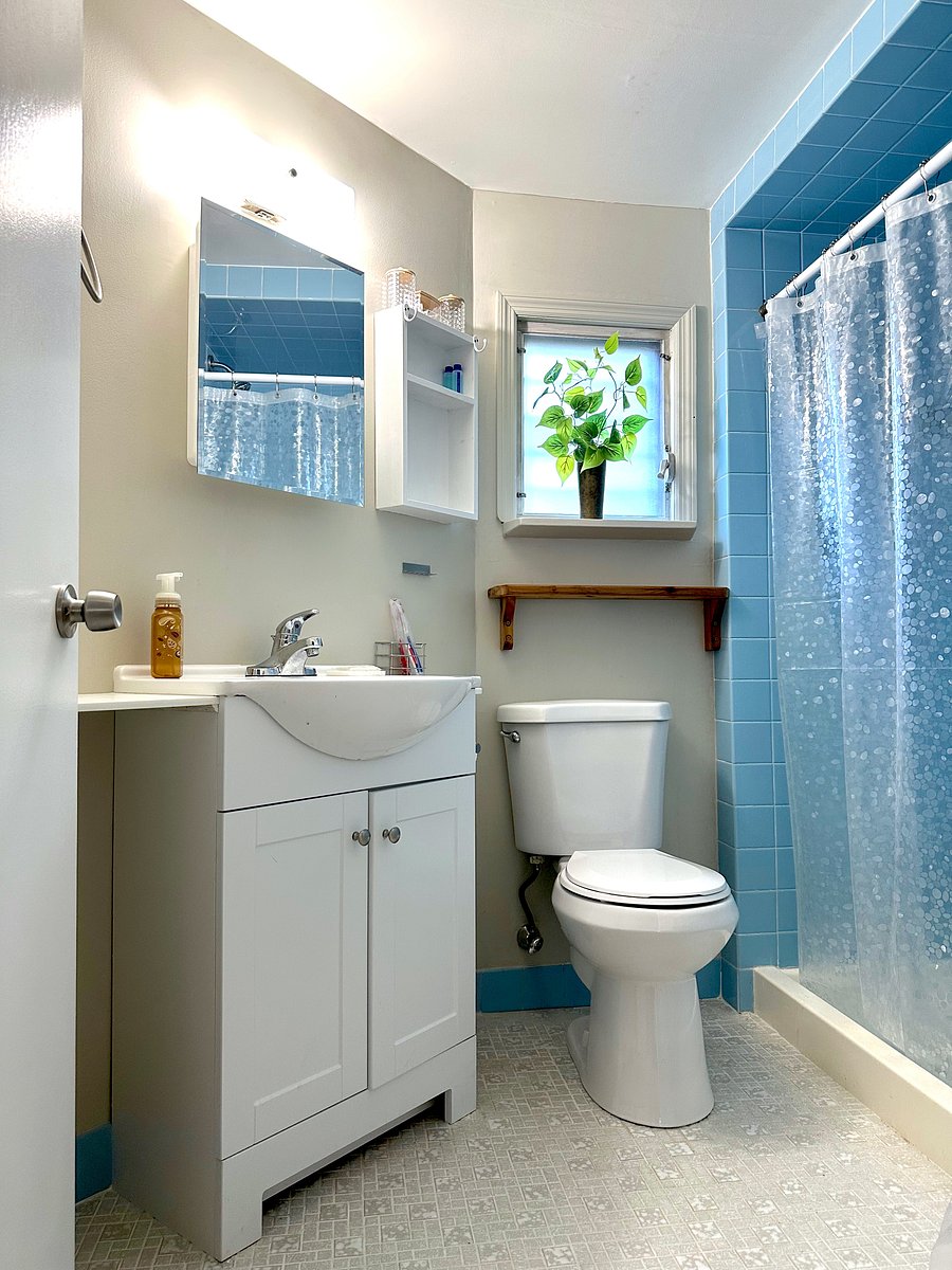 I love shelves in the bathroom, and just installed another lovely wooden shelf below the window... for you.
