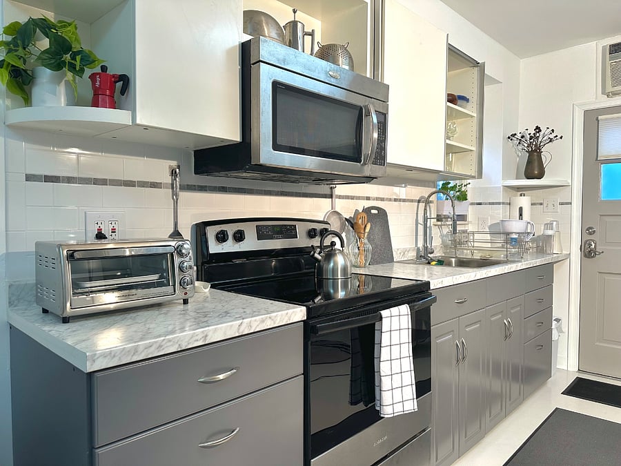 The kitchen area has both a range and oven, as well as a microwave above the stove.