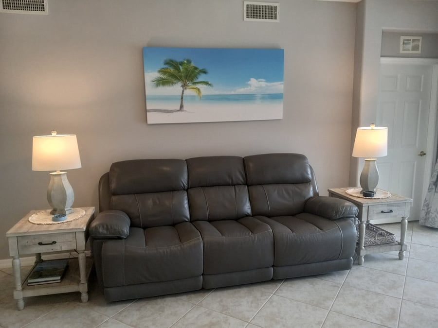 Leather reclining sofa with a large screen TV to enjoy.